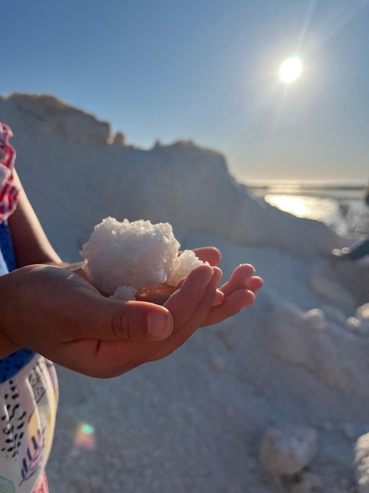 A handful of freshly harvested salt in the Marsala salt pans, backlit