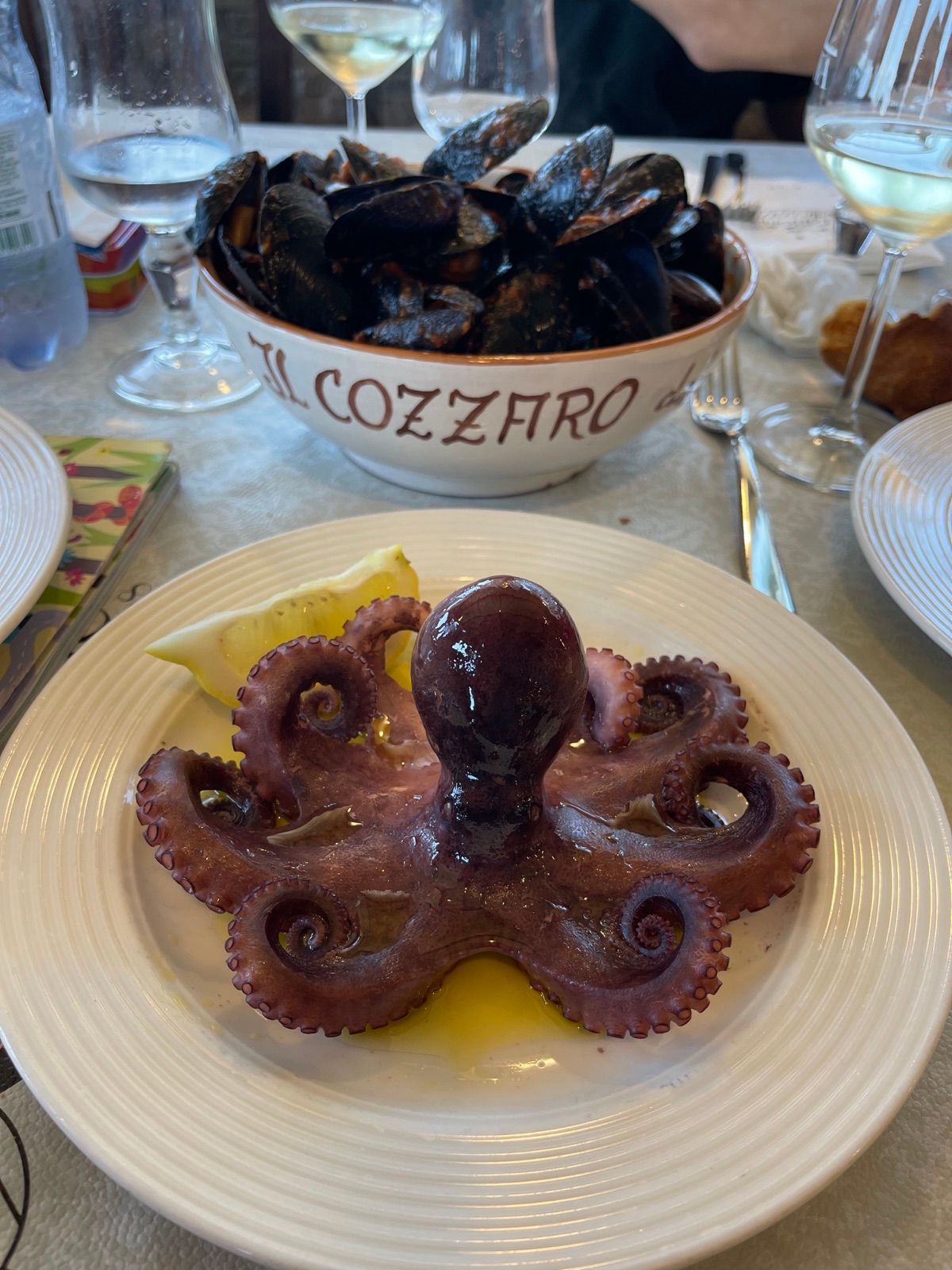 Un polpo intero nel piatto, e una zuppiera di cozze dietro